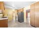 Spacious kitchen features ample wood cabinetry, speckled floors, and stainless steel refrigerator at 205 Kilmer Ln, Winter Haven, FL 33884