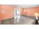 Bright living room with terrazzo floors and access to the sunroom at 205 Kilmer Ln, Winter Haven, FL 33884