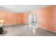 Bright living room with terrazzo floors and access to the sunroom at 205 Kilmer Ln, Winter Haven, FL 33884