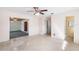 Bright living room features terrazzo floors, ceiling fan, and access to a bonus room and bathroom at 205 Kilmer Ln, Winter Haven, FL 33884