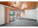 Bright sun room featuring a wood ceiling and access to the backyard at 205 Kilmer Ln, Winter Haven, FL 33884