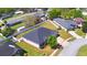 Features aerial view of home on a large lot with green lawn, white fence and mature trees at 2110 Saddlewood Dr, Bartow, FL 33830