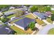 Features aerial view of home on a large lot with green lawn, white fence and mature trees at 2110 Saddlewood Dr, Bartow, FL 33830