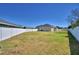Expansive backyard, enclosed by a pristine white fence, offering privacy and room for outdoor activities at 2110 Saddlewood Dr, Bartow, FL 33830