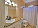 Well-lit bathroom featuring a granite countertop and a shower with a white curtain at 2110 Saddlewood Dr, Bartow, FL 33830