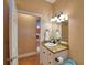 Half bath featuring a granite countertop with white cabinets and wood-look flooring at 2110 Saddlewood Dr, Bartow, FL 33830