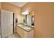 Bright bathroom featuring double sinks, vanity with storage, and large mirror at 2110 Saddlewood Dr, Bartow, FL 33830