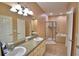 Expansive bathroom featuring double sinks, vanity with storage, shower, and tub at 2110 Saddlewood Dr, Bartow, FL 33830