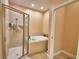Bathroom showcasing a glass-enclosed shower and soaking tub, creating a spa-like experience at 2110 Saddlewood Dr, Bartow, FL 33830
