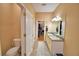 Bathroom featuring double sinks, white cabinets, and walk-in closet at 2110 Saddlewood Dr, Bartow, FL 33830