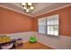 The dining room boasts elegant wainscoting, and a traditional chandelier at 2110 Saddlewood Dr, Bartow, FL 33830
