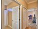 Hallway view showcasing a bathroom with a shower curtain, and a door leading to another room at 2110 Saddlewood Dr, Bartow, FL 33830