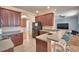 Stylish kitchen featuring wood cabinets, modern appliances, and a breakfast bar at 2110 Saddlewood Dr, Bartow, FL 33830