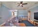 Spacious living room with hardwood floors, gray sofa, ceiling fan, and comfortable seating area at 2110 Saddlewood Dr, Bartow, FL 33830