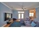A comfortable living room with a ceiling fan, tv and an open doorway to the kitchen at 2110 Saddlewood Dr, Bartow, FL 33830
