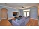 Comfortable living room featuring hardwood floors, a large gray sectional, and plenty of natural light at 2110 Saddlewood Dr, Bartow, FL 33830