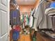 Spacious walk-in closet providing ample storage with shelving, hanging rods, and shoe rack at 2110 Saddlewood Dr, Bartow, FL 33830
