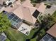 An aerial view of a home featuring a swimming pool, fire pit, tile roof, and solar panels at 2204 Kettle Dr, Orlando, FL 32835