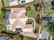 A property featuring a tile roof, swimming pool, and meticulously landscaped yard, as seen from above at 2204 Kettle Dr, Orlando, FL 32835