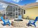Backyard features a brick patio with a fire pit, seating, and a view of the screened pool at 2204 Kettle Dr, Orlando, FL 32835