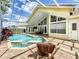 A beautiful screened-in pool and chair with stylish brick deck at 2204 Kettle Dr, Orlando, FL 32835
