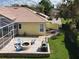 Inviting backyard with a fire pit, patio, screen enclosed lanai, and well-maintained landscaping at 2204 Kettle Dr, Orlando, FL 32835