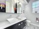 Bathroom with double sinks, wood-look tile floor, and modern fixtures at 2204 Kettle Dr, Orlando, FL 32835