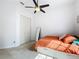 This bedroom features a ceiling fan, neutral carpet, and a closet for storage at 2204 Kettle Dr, Orlando, FL 32835