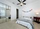 Bedroom with mirrored closet doors, carpet, and large ceiling fan with lighting at 2204 Kettle Dr, Orlando, FL 32835