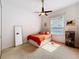 This bedroom features a ceiling fan, a full length mirror, and a window letting in natural light at 2204 Kettle Dr, Orlando, FL 32835