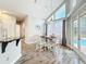 Bright breakfast nook with a round table, white chairs, large windows, and access to the pool area at 2204 Kettle Dr, Orlando, FL 32835