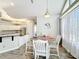 Charming breakfast nook featuring a round table, white chairs, and natural light from the large windows at 2204 Kettle Dr, Orlando, FL 32835