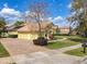 Charming home with a well-manicured lawn, a brick paved driveway, and a tile roof at 2204 Kettle Dr, Orlando, FL 32835