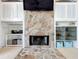 Fireplace with stone facade and built-in shelving and cabinets at 2204 Kettle Dr, Orlando, FL 32835