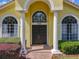 Home's arched entrance with white columns, detailed transom window, and 'hello' welcome mat at 2204 Kettle Dr, Orlando, FL 32835