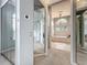Hallway view leading to a luxurious bathroom with mirrored closet doors and elegant chandelier at 2204 Kettle Dr, Orlando, FL 32835