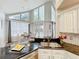 Bright, eat-in kitchen featuring granite counters, stainless steel sink, and views of the outdoor pool at 2204 Kettle Dr, Orlando, FL 32835