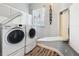 This laundry room features a full size washer and dryer and a folding table at 2204 Kettle Dr, Orlando, FL 32835