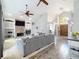 Spacious living room features a stone fireplace, high ceilings, ceiling fans, built-in shelving, and hardwood flooring at 2204 Kettle Dr, Orlando, FL 32835