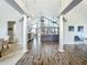 Spacious living room with high ceilings, wood floors, columns, and lots of natural light at 2204 Kettle Dr, Orlando, FL 32835
