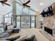 Bright living room open to the dining area features a stone fireplace and pool views at 2204 Kettle Dr, Orlando, FL 32835