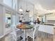 Open living space with breakfast nook, kitchen, and living room featuring hardwood floors and vaulted ceilings at 2204 Kettle Dr, Orlando, FL 32835