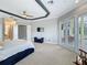 Main bedroom featuring tray ceiling, seating area, and access to the en-suite bathroom and pool area at 2204 Kettle Dr, Orlando, FL 32835