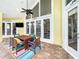 Covered patio features a ceiling fan, an outdoor dining set, and views of the backyard at 2204 Kettle Dr, Orlando, FL 32835