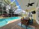 Covered patio features a ceiling fan, an outdoor dining set, and views of the sparkling pool at 2204 Kettle Dr, Orlando, FL 32835