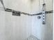 Modern shower with decorative accent tiles, hand shower and built-in niche at 2204 Kettle Dr, Orlando, FL 32835