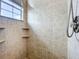 Shower with tiled walls, a hand shower, and corner shelves at 2204 Kettle Dr, Orlando, FL 32835