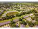 Aerial view showcasing a beautiful community with a pond and well-maintained landscaping at 2254 Firestone Pl # 2254, Winter Haven, FL 33884