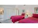 Comfortable bedroom featuring two twin beds with red quilts, a closet and a connected bathroom at 2300 N Scenic Hwy # 89, Lake Wales, FL 33898
