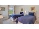 Cozy bedroom featuring two twin beds with blue comforters and matching decor at 2300 N Scenic Hwy # 89, Lake Wales, FL 33898